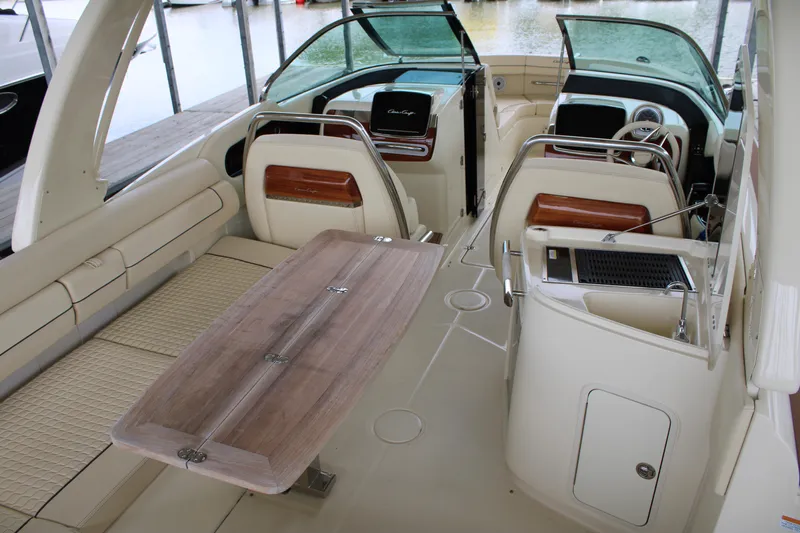 America Yacht Photos Pics 2023 Chris-Craft Launch 31 GT interior with elegant seating and wooden table.