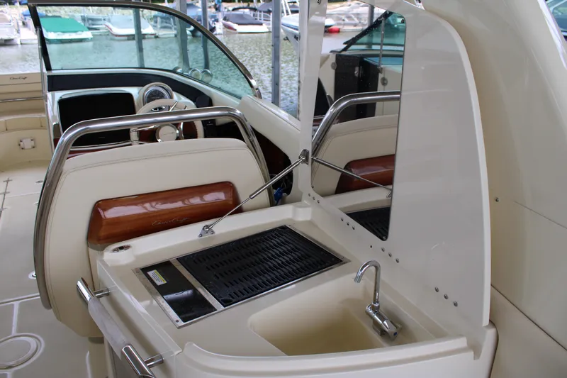 America Yacht Photos Pics 2023 Chris-Craft Launch 31 GT interior with sink and grill, docked at marina.