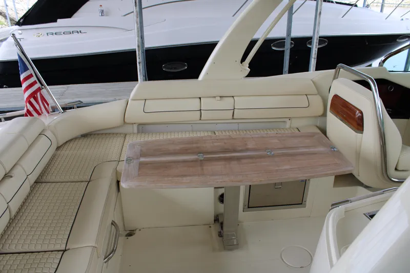 America Yacht Photos Pics 2023 Chris-Craft Launch 31 GT interior with beige seating and wooden table.