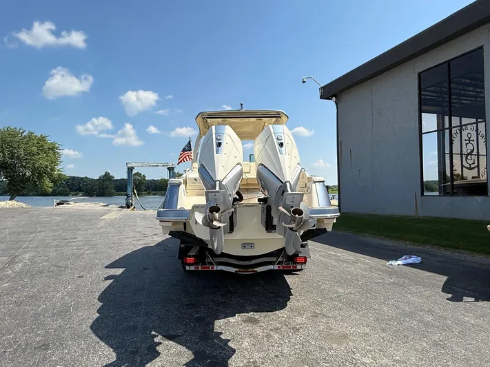America Yacht Photos Pics 2023 Chris-Craft Launch 31 GT boat with dual engines, parked near a waterfront.