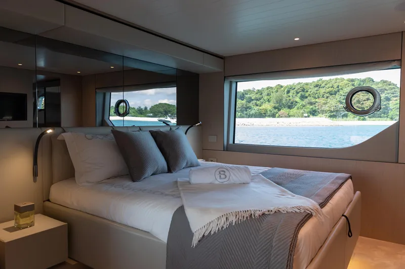  Yacht Photos Pics Luxurious bedroom interior of 2022 Bluegame BGX70 yacht with scenic ocean view.