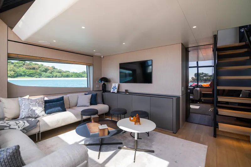  Yacht Photos Pics Luxurious interior of 2022 Bluegame BGX70 yacht with modern furnishings and scenic window view.