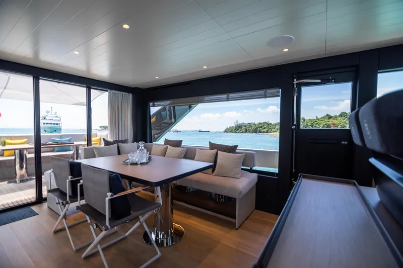  Yacht Photos Pics Luxurious interior of 2022 Bluegame BGX70 yacht with ocean view and elegant seating area.
