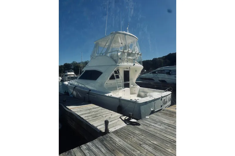 Rah Rah Yacht Photos Pics 2000 Riviera 40 yacht docked at marina under clear blue sky.