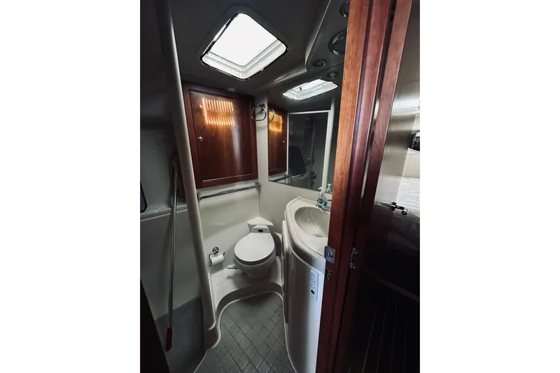 Rah Rah Yacht Photos Pics Bathroom interior of 2000 Riviera 40 yacht with wooden cabinets and skylight.