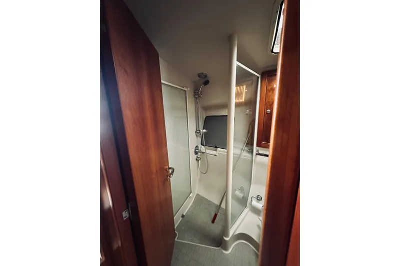 Rah Rah Yacht Photos Pics Bathroom interior of 2000 Riviera 40 yacht with shower and wooden cabinetry.
