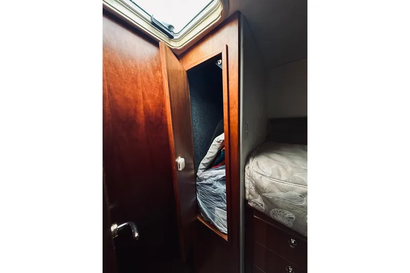 Rah Rah Yacht Photos Pics Interior of 2000 Riviera 40 yacht showing wooden cabinet and cozy bed.