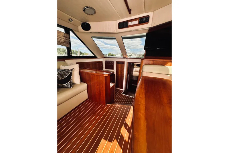 Rah Rah Yacht Photos Pics Luxurious interior of a 2000 Riviera 40 yacht with wooden finishes and plush seating.
