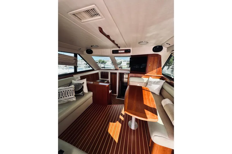 Rah Rah Yacht Photos Pics Interior of 2000 Riviera 40 yacht with elegant wood finish and comfortable seating.