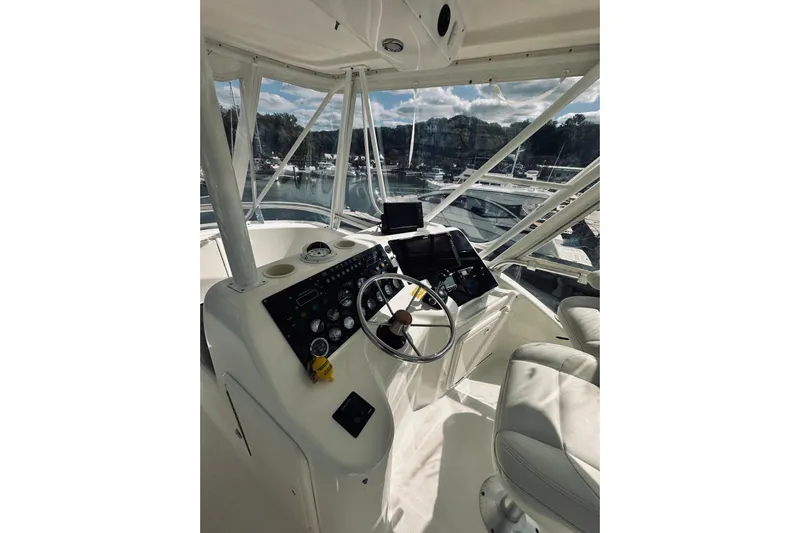 Rah Rah Yacht Photos Pics Helm of 2000 Riviera 40 yacht with steering wheel and navigation equipment.