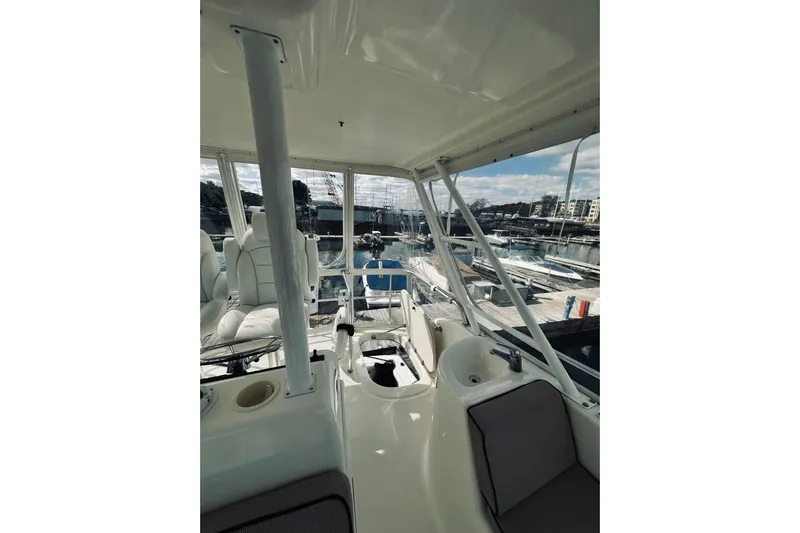 Rah Rah Yacht Photos Pics Interior view of 2000 Riviera 40 yacht at marina, showcasing seating and helm area.