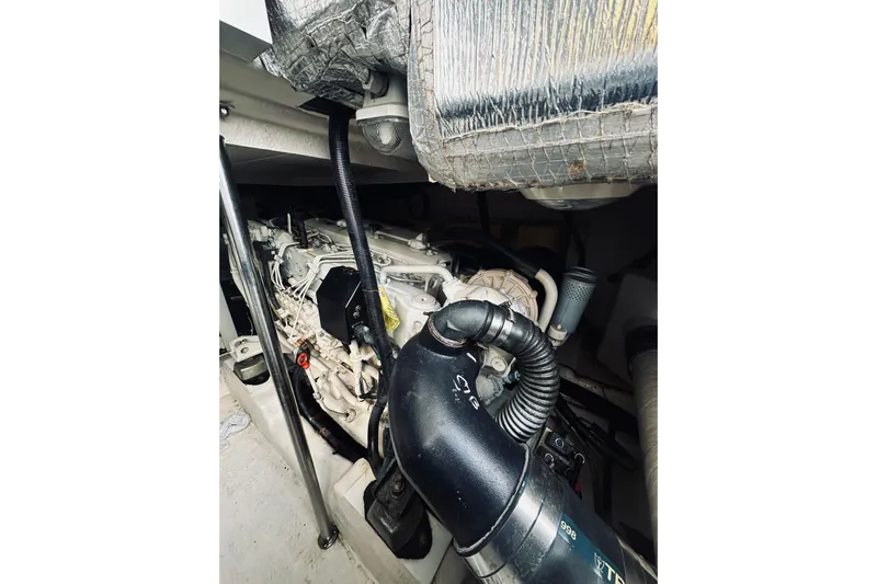 Rah Rah Yacht Photos Pics Engine compartment of a 2000 Riviera 40 boat, showcasing mechanical components and piping.