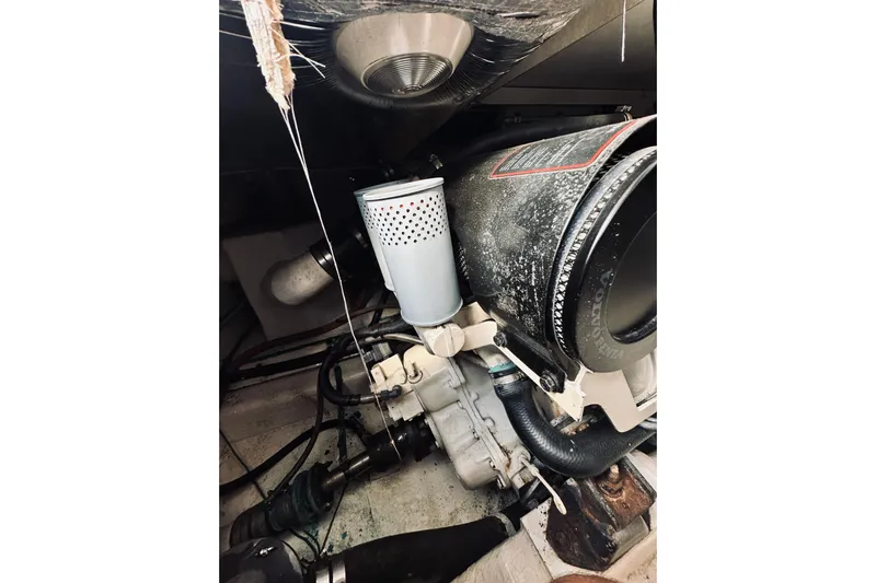 Rah Rah Yacht Photos Pics Engine compartment of a 2000 Riviera 40 boat, featuring mechanical components and hoses.