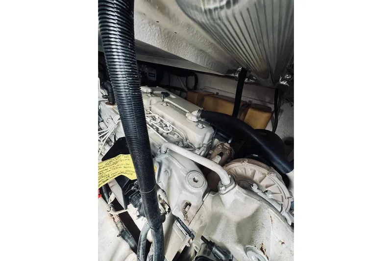 Rah Rah Yacht Photos Pics Engine compartment of a 2000 Riviera 40 boat, showcasing mechanical components and hoses.