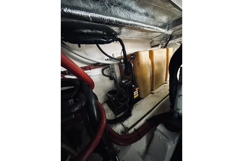 Rah Rah Yacht Photos Pics Engine room of 2000 Riviera 40 boat with pipes and equipment.