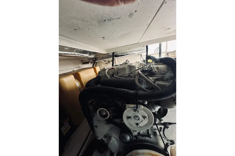 Rah Rah Yacht Photos Pics Engine compartment of a 2000 Riviera 40 boat, showcasing mechanical components and hoses.