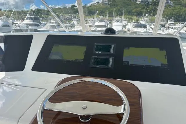  Yacht Photos Pics Helm of 2007 Viking 52 Convertible yacht with navigation screens in marina setting.