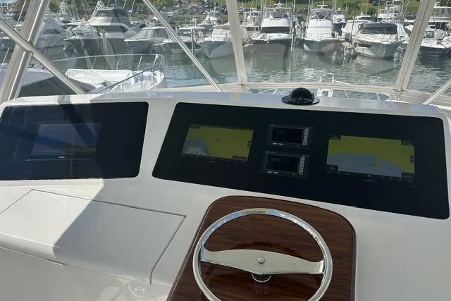  Yacht Photos Pics Helm of 2007 Viking 52 Convertible yacht with navigation screens and steering wheel.