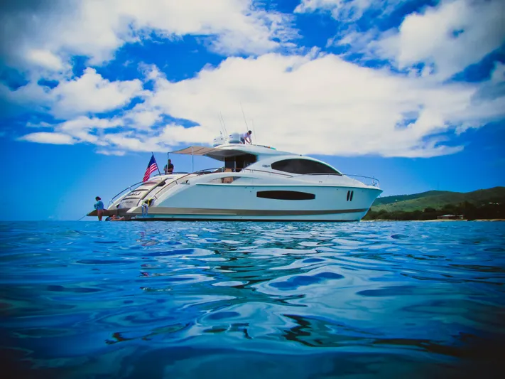 Lovin Life Yacht Photos Pics Luxury 2008 Lazzara LSX 75 yacht on clear blue water under vibrant sky.