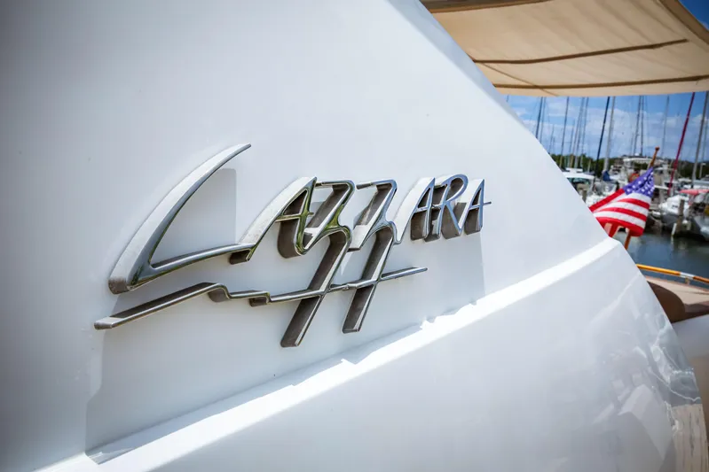 Lovin Life Yacht Photos Pics 2008 Lazzara LSX 75 yacht with logo, docked in marina.