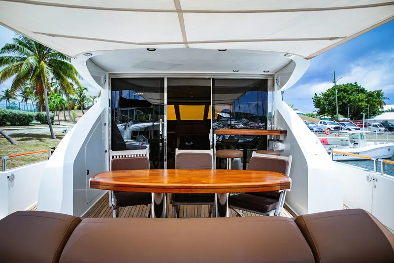 Lovin Life Yacht Photos Pics Luxurious 2008 Lazzara LSX 75 yacht deck with elegant seating and tropical backdrop.