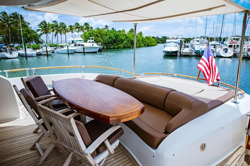 Lovin Life Yacht Photos Pics Luxury 2008 Lazzara LSX 75 yacht deck with seating, table, and American flag.