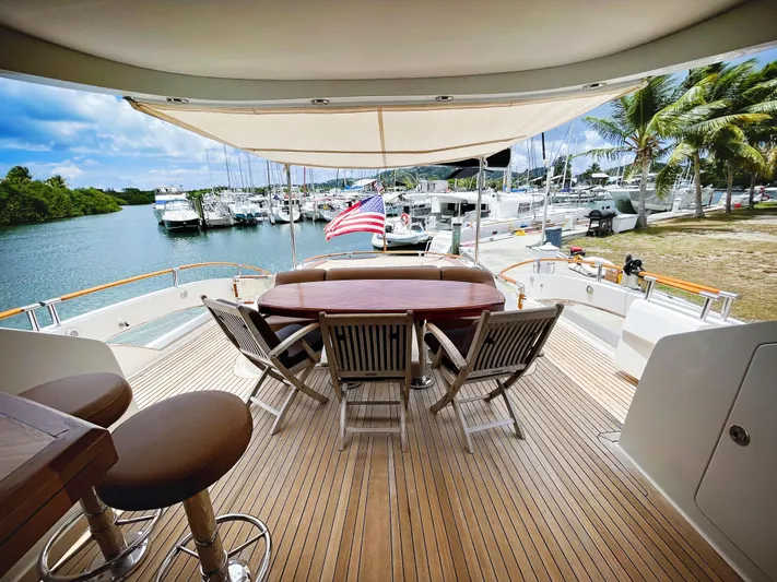 Lovin Life Yacht Photos Pics Luxury 2008 Lazzara LSX 75 yacht deck with seating, docked by marina.