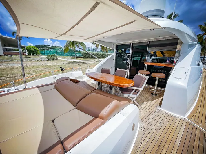 Lovin Life Yacht Photos Pics Luxurious 2008 Lazzara LSX 75 yacht deck with seating and dining area.