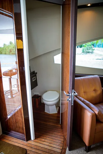 Lovin Life Yacht Photos Pics Interior of 2008 Lazzara LSX 75 yacht showing bathroom and seating area.