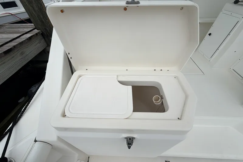 Panacea Yacht Photos Pics Open storage compartment on 1998 Cabo 31 Express boat deck.