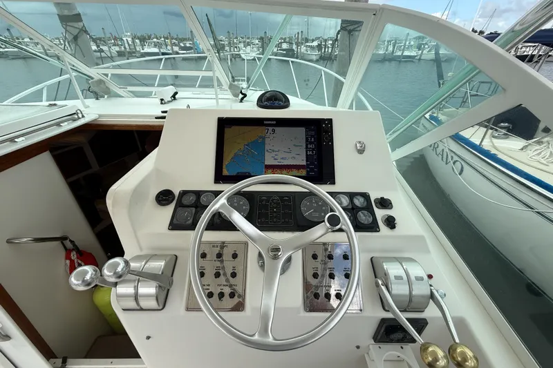 Panacea Yacht Photos Pics Helm of 1998 Cabo 31 Express boat with navigation equipment and steering wheel.