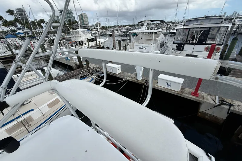 Panacea Yacht Photos Pics 1998 Cabo 31 Express yacht docked at a marina with other boats.