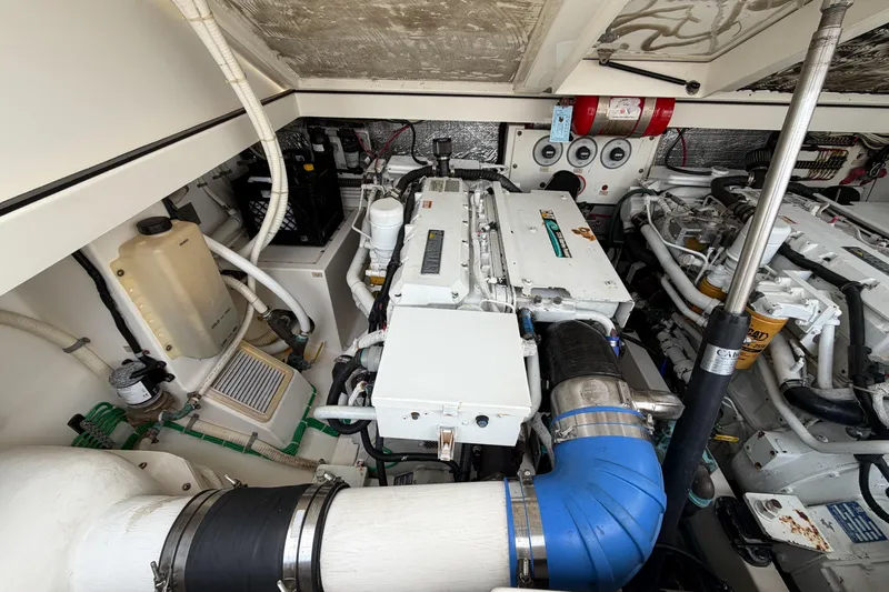 Panacea Yacht Photos Pics Engine room of a 1998 Cabo 31 Express boat, showcasing dual engines and mechanical components.