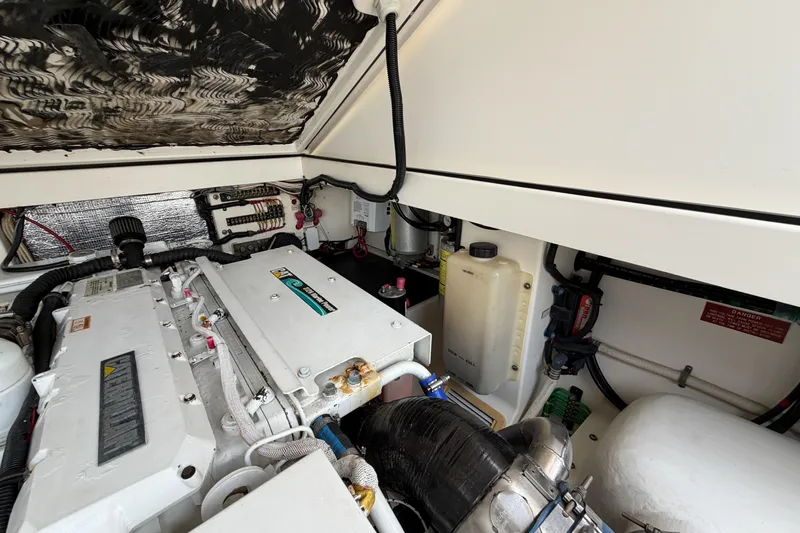 Panacea Yacht Photos Pics Engine compartment of a 1998 Cabo 31 Express boat, showcasing mechanical components.