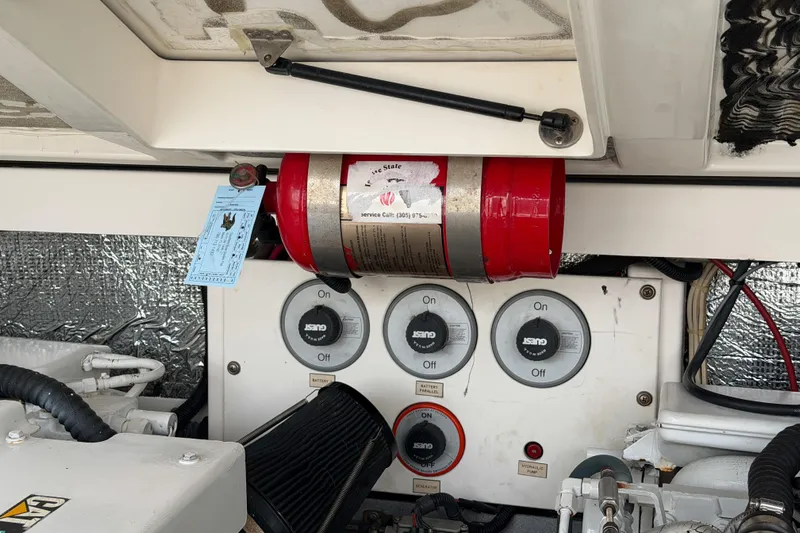 Panacea Yacht Photos Pics Engine room of 1998 Cabo 31 Express with fire extinguisher and control panel.