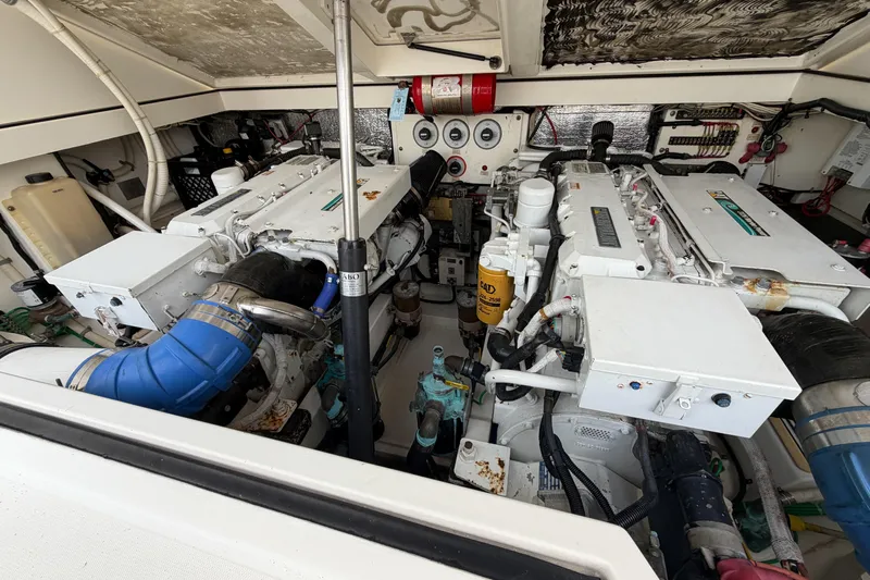 Panacea Yacht Photos Pics Engine room of a 1998 Cabo 31 Express boat, featuring dual engines and mechanical components.