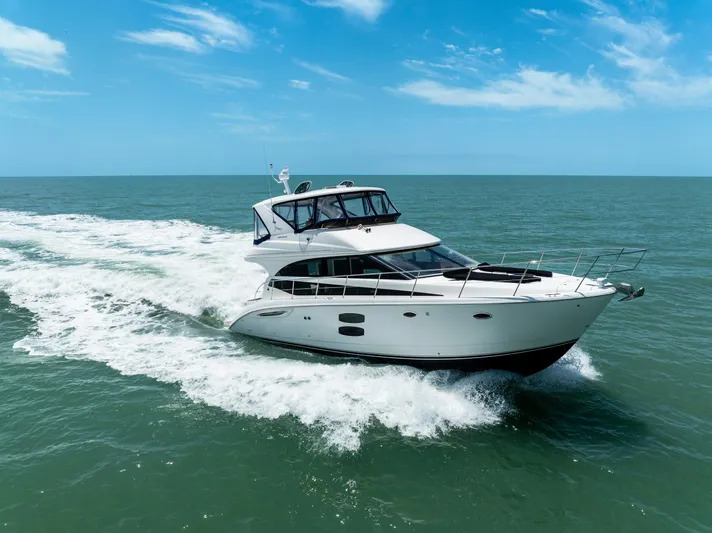  Yacht Photos Pics 2012 Meridian 441 Sedan cruising on open sea under clear blue sky.