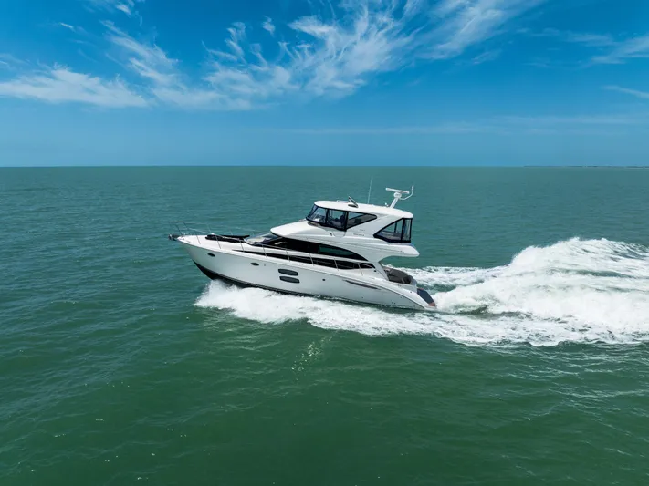  Yacht Photos Pics 2012 Meridian 441 Sedan yacht cruising on open sea under clear blue sky.