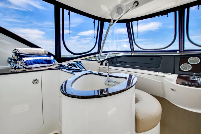  Yacht Photos Pics Luxurious interior of 2012 Meridian 441 Sedan yacht with sleek design and panoramic windows.