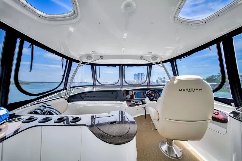  Yacht Photos Pics Interior of 2012 Meridian 441 Sedan yacht with panoramic windows and modern helm.