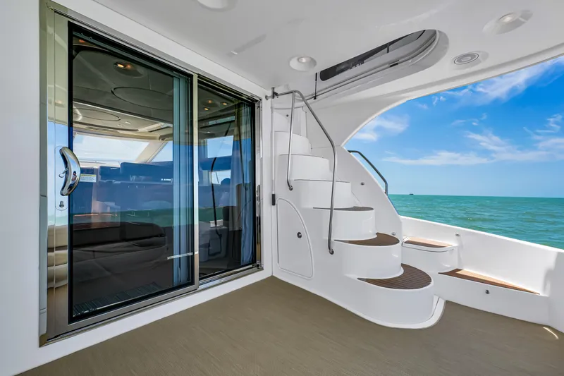  Yacht Photos Pics 2012 Meridian 441 Sedan yacht interior with spiral staircase and ocean view.