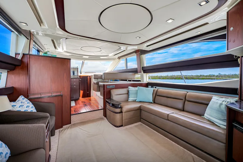 Yacht Photos Pics Luxurious interior of a 2012 Meridian 441 Sedan yacht with plush seating and panoramic windows.