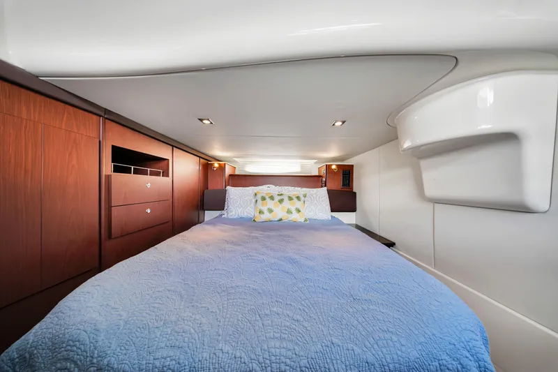  Yacht Photos Pics Luxurious cabin interior of 2012 Meridian 441 Sedan yacht with cozy bed and wooden cabinetry.