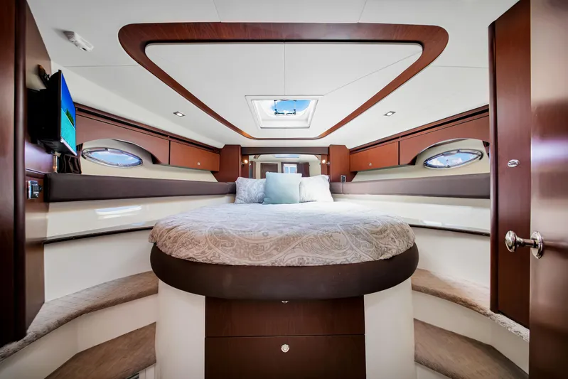  Yacht Photos Pics Luxurious interior of 2012 Meridian 441 Sedan yacht with elegant wood finishes and cozy bedding.