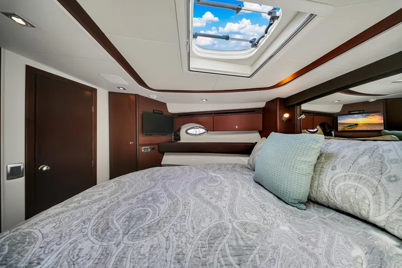  Yacht Photos Pics Luxurious bedroom interior of 2012 Meridian 441 Sedan yacht with skylight and elegant bedding.