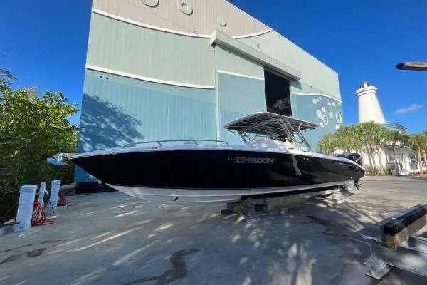  Yacht Photos Pics 2013 Midnight Express 39 Open boat docked near a large building and lighthouse.