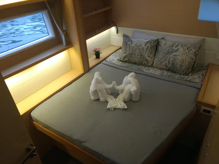 Nauti By Nature II Yacht Photos Pics Luxurious cabin interior of 2017 Lagoon 52 yacht with elegant bedding and towel art.