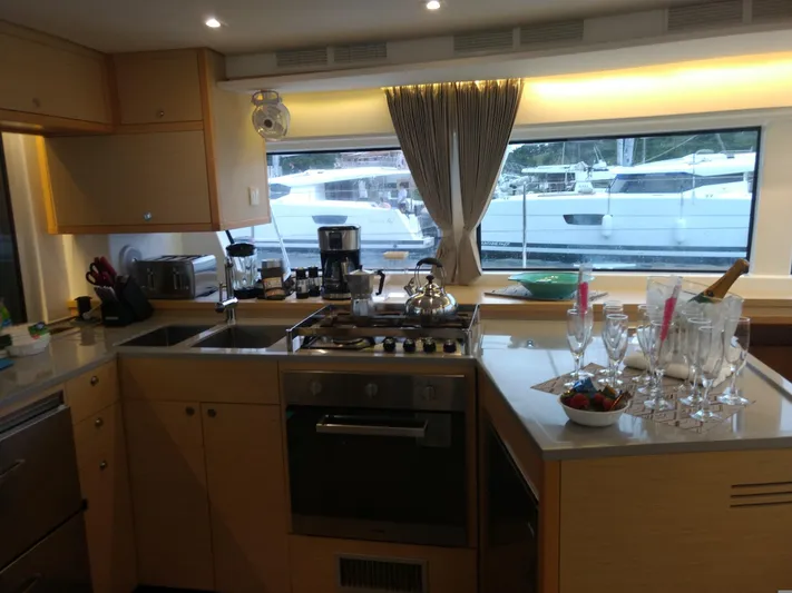 Nauti By Nature II Yacht Photos Pics Modern kitchen interior on 2017 Lagoon 52 yacht with appliances and dining setup.