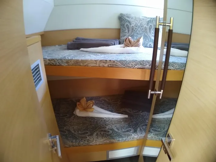 Nauti By Nature II Yacht Photos Pics Bunk beds in a 2017 Lagoon 52 yacht cabin with decorative towels and pillows.