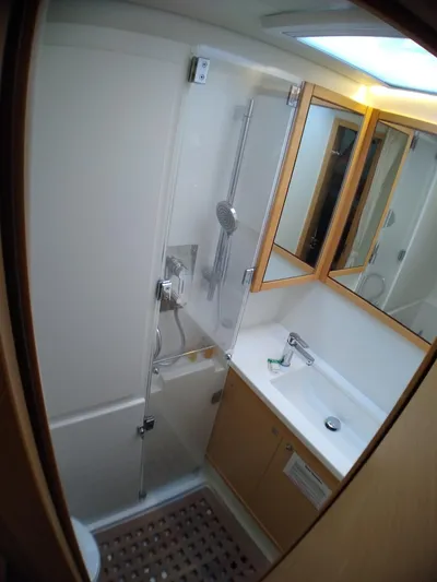 Nauti By Nature II Yacht Photos Pics 2017 Lagoon 52 yacht bathroom with shower, sink, and mirrored cabinets.